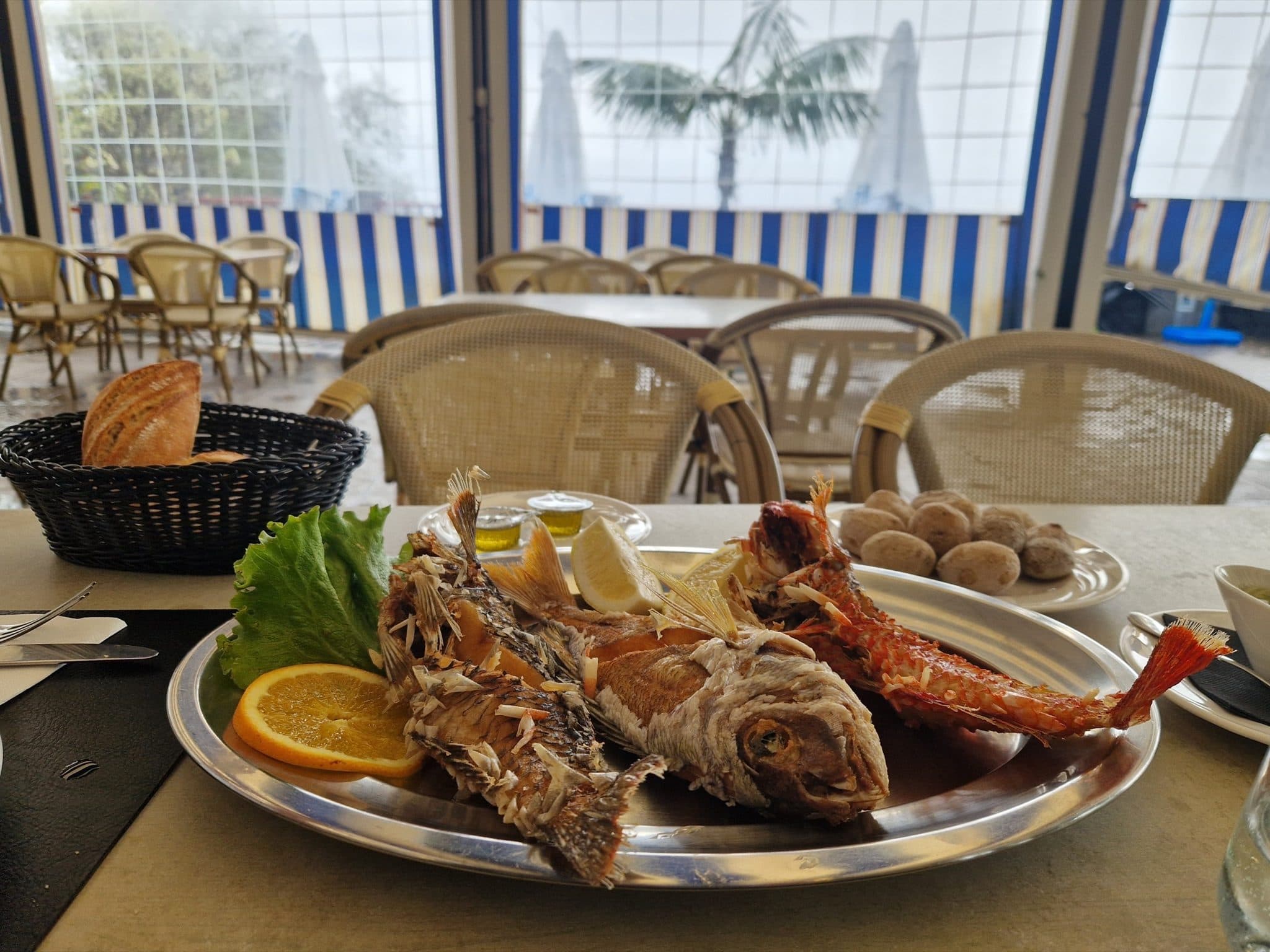 Platter of whole grilled fish with lemon