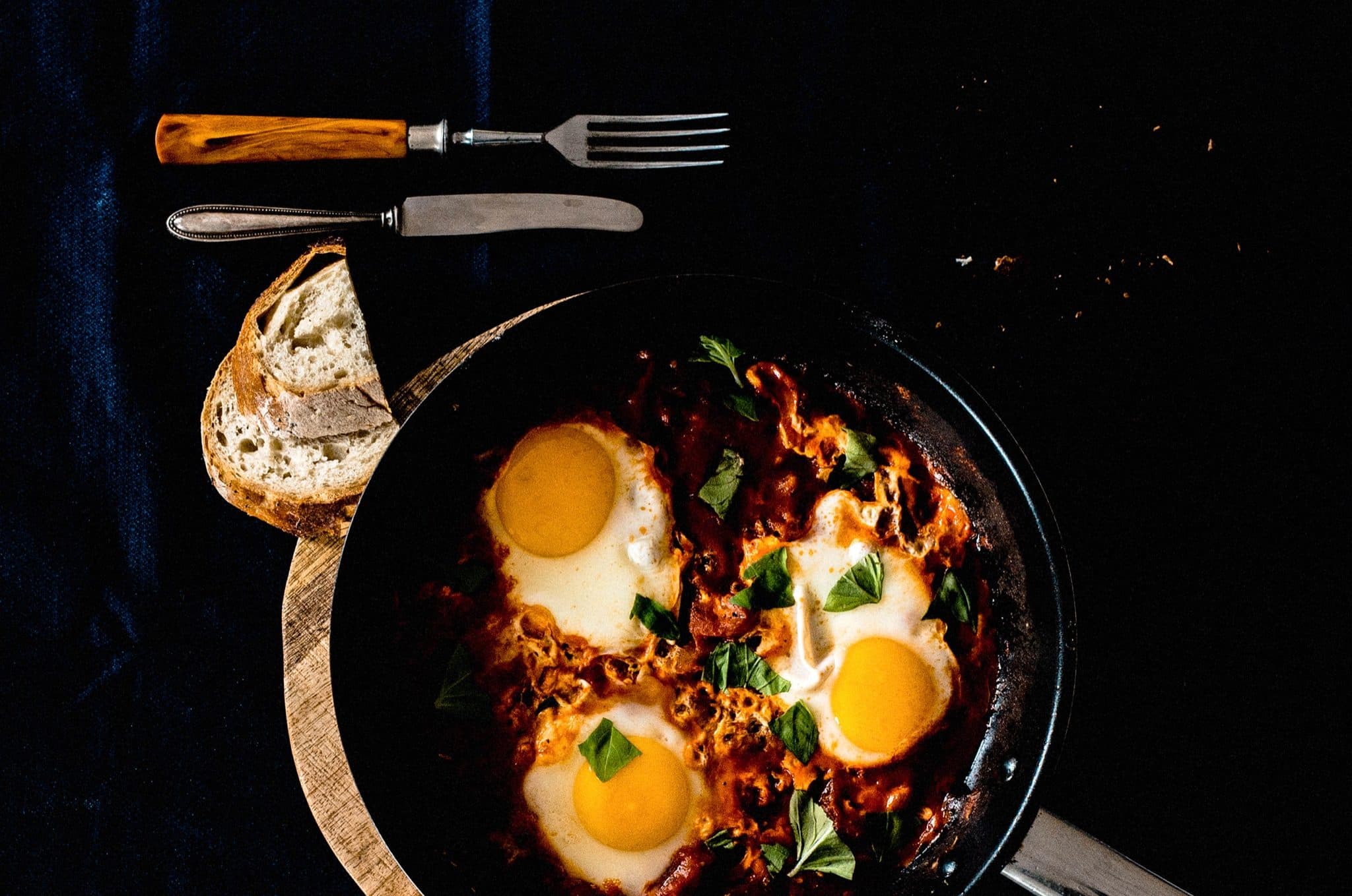 Shakshuka in a pan with bread