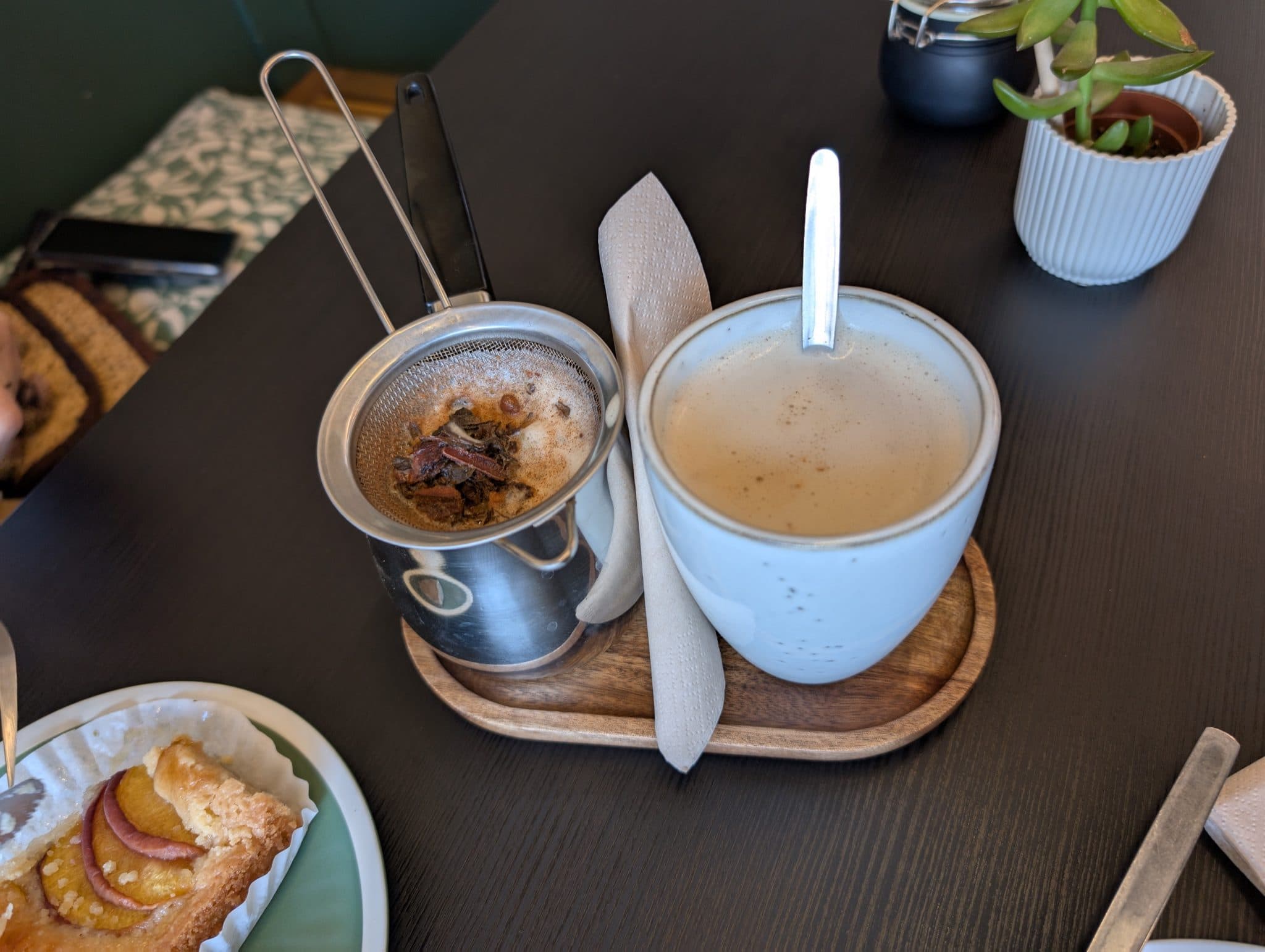 Spiced milk tea served with a strainer