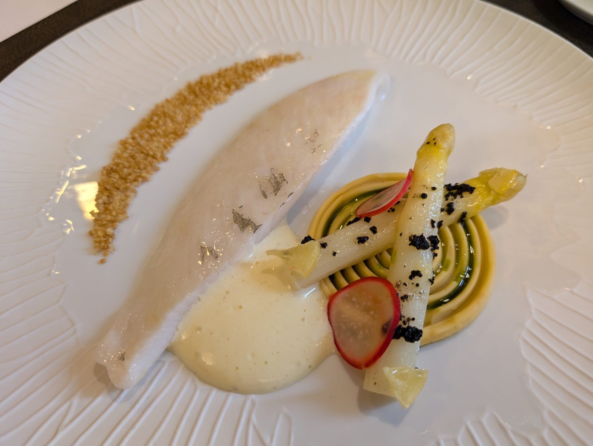 Plated fish with white asparagus and quinoa